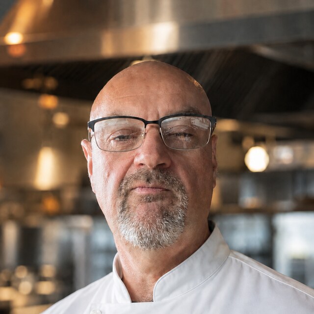 Andy Bouchard, executive chef and founder of RestaurantOpsApp, in chef whites in a working kitchen